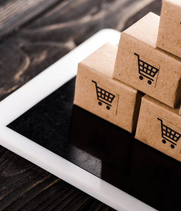 selective focus of small carton boxes on digital tablet, e-commerce concept